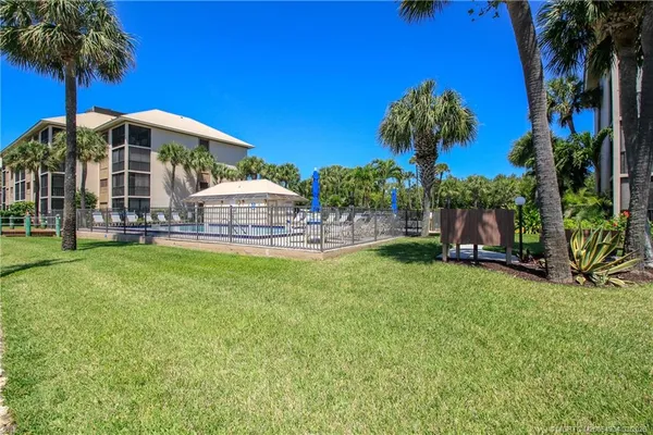 a view of a house with a yard and sitting area