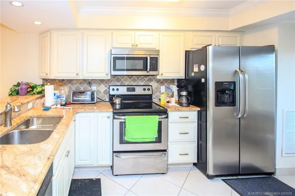 a kitchen with a refrigerator and a sink