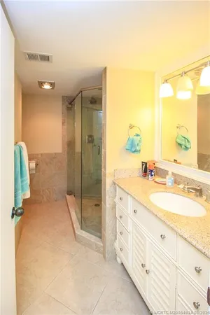a spacious bathroom with a double vanity sink and mirror