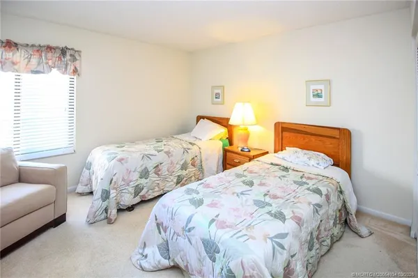 a bedroom with two beds and a couch