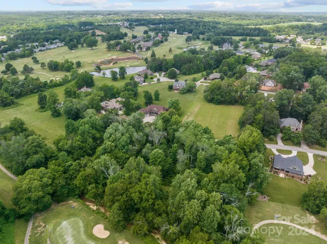 an aerial view of a houses with a yard