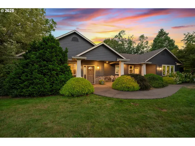 a front view of a house with a garden