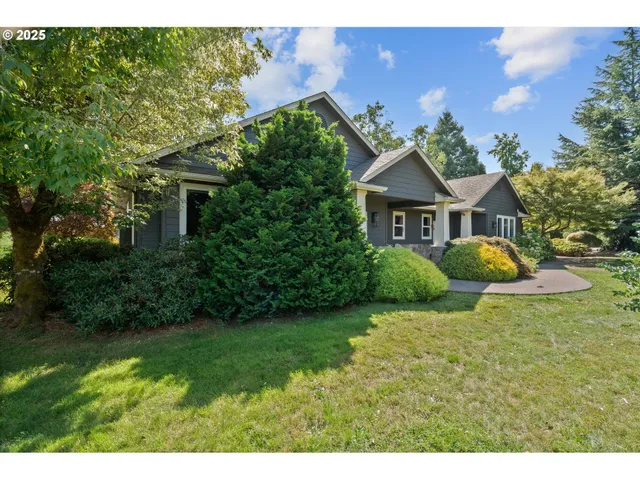 a living room with furniture a fireplace and a large window