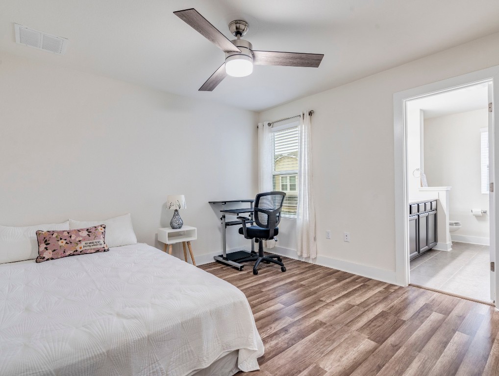 7408 Merrick Lane, Unit 42 Austin, TX 78745 - Photo 17 of 28 Secondary bedroom with evp flooring, ensuite bathroom and ceiling fan
