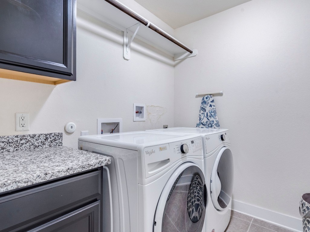 7408 Merrick Lane, Unit 42 Austin, TX 78745 - Photo 23 of 28 Washroom with cabinet space, and separate washer and dryer