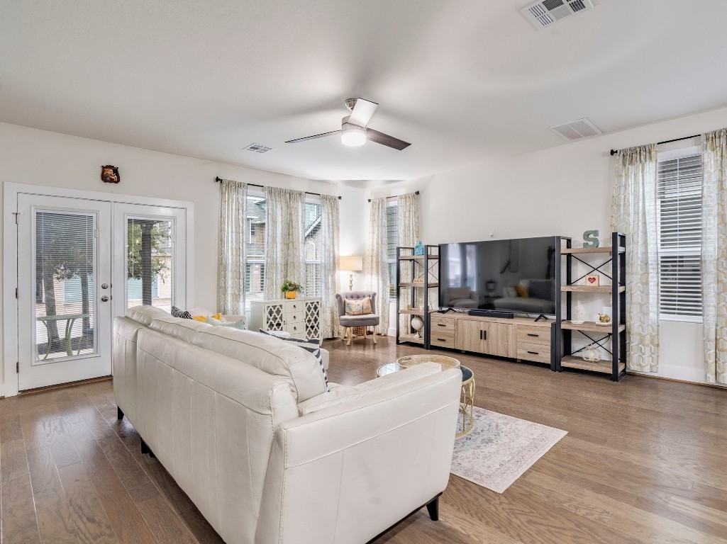 7408 Merrick Lane, Unit 42 Austin, TX 78745 - Photo 5 of 28 Living room with wood finished floors, a ceiling fan, and french doors
