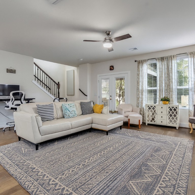 7408 Merrick Lane, Unit 42 Austin, TX 78745 - Photo 7 of 28 Living room with beautiful natural lighting from windows, ceiling fan