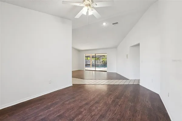 a living room with furniture a flat screen tv and a large window