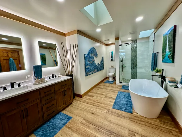 a large spacious bathroom with a double vanity sink a mirror and a shower