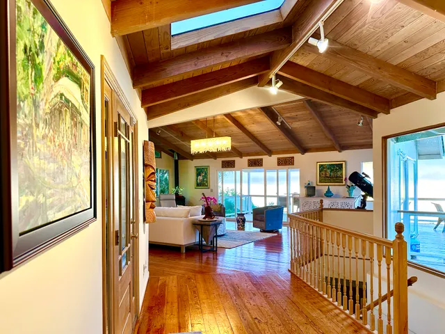 a view of a livingroom with furniture wooden floor and windows