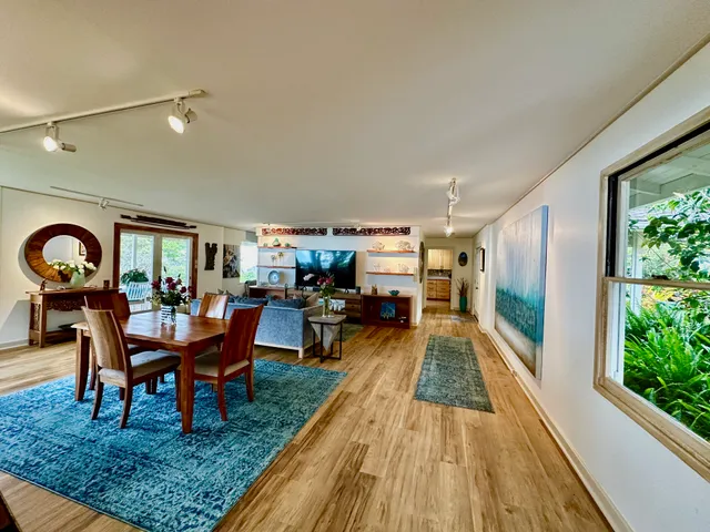 a dining room with furniture and wooden floor