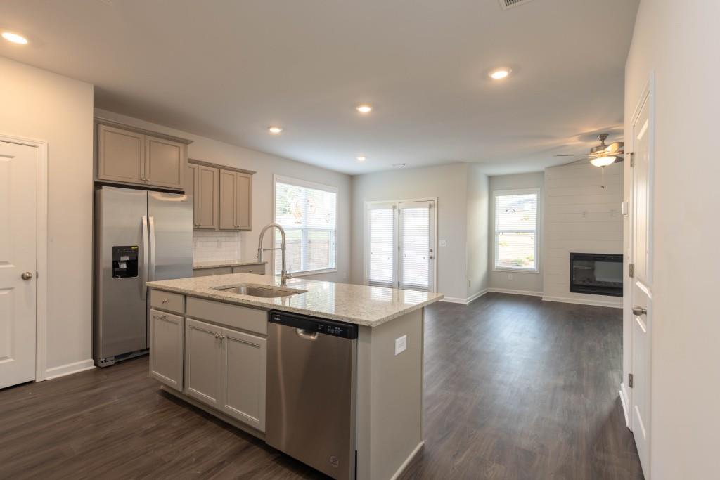 2773 Apperson Way Suwanee, GA 30024 - Photo 5 of 24 a kitchen with a sink a refrigerator and window