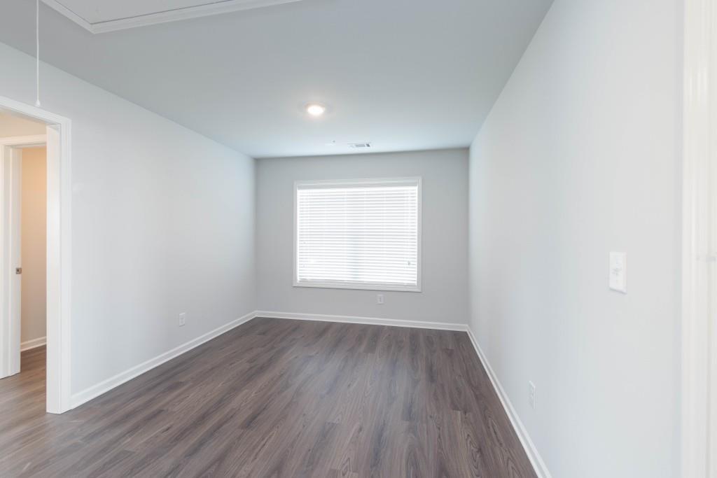 2773 Apperson Way Suwanee, GA 30024 - Photo 9 of 24 an empty room with wooden floor and windows