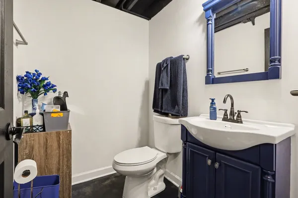 a bathroom with a sink toilet and mirror