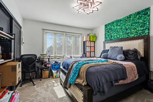 a bedroom with a bed and a chandelier