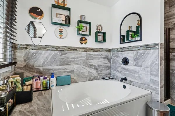 a bathroom with a tub and sink