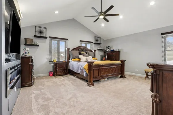 a bedroom with bed and a chandelier