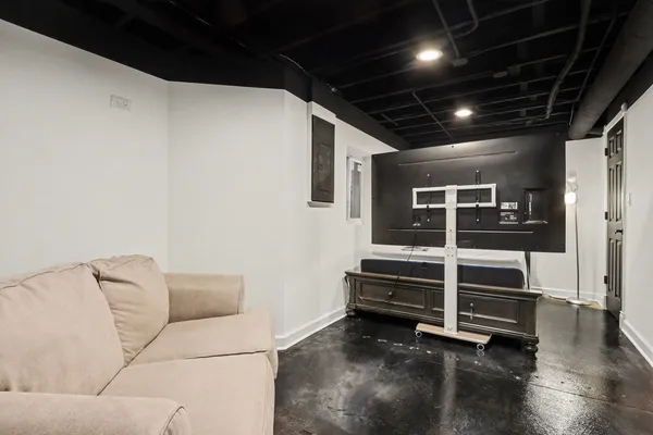 a view of an empty room with wooden floor and windows