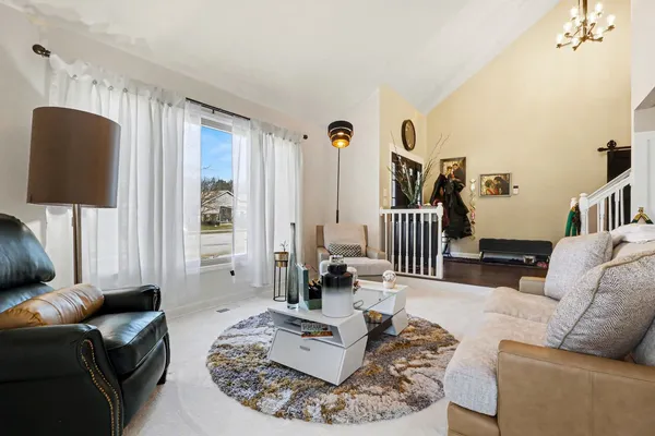 a living room with furniture and a lamp