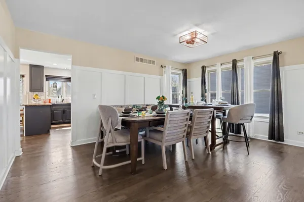 a view of a dining room with furniture and wooden floor