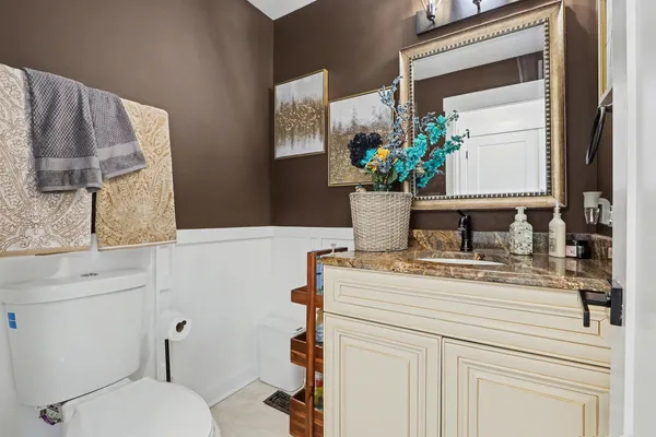 a bathroom with a sink a toilet and mirror