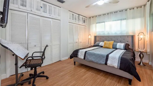 a bedroom with a bed chair and window