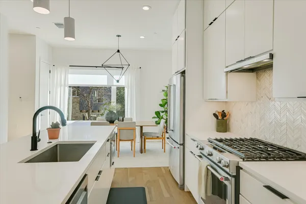 a kitchen with a stove a sink and a refrigerator