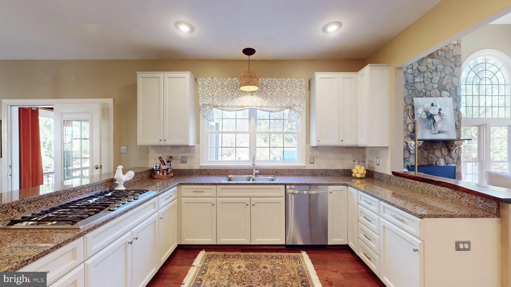 9728 Middleton Ridge Road Vienna, VA 22182 - Photo 14 of 81 a kitchen with a sink stove and cabinets