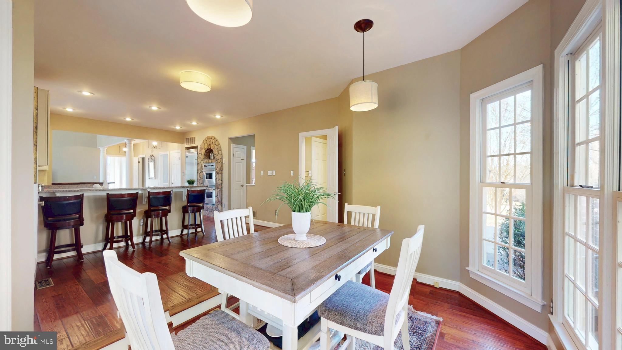 9728 Middleton Ridge Road Vienna, VA 22182 - Photo 19 of 81 a view of a dining room and livingroom with furniture wooden floor a rug a chandelier