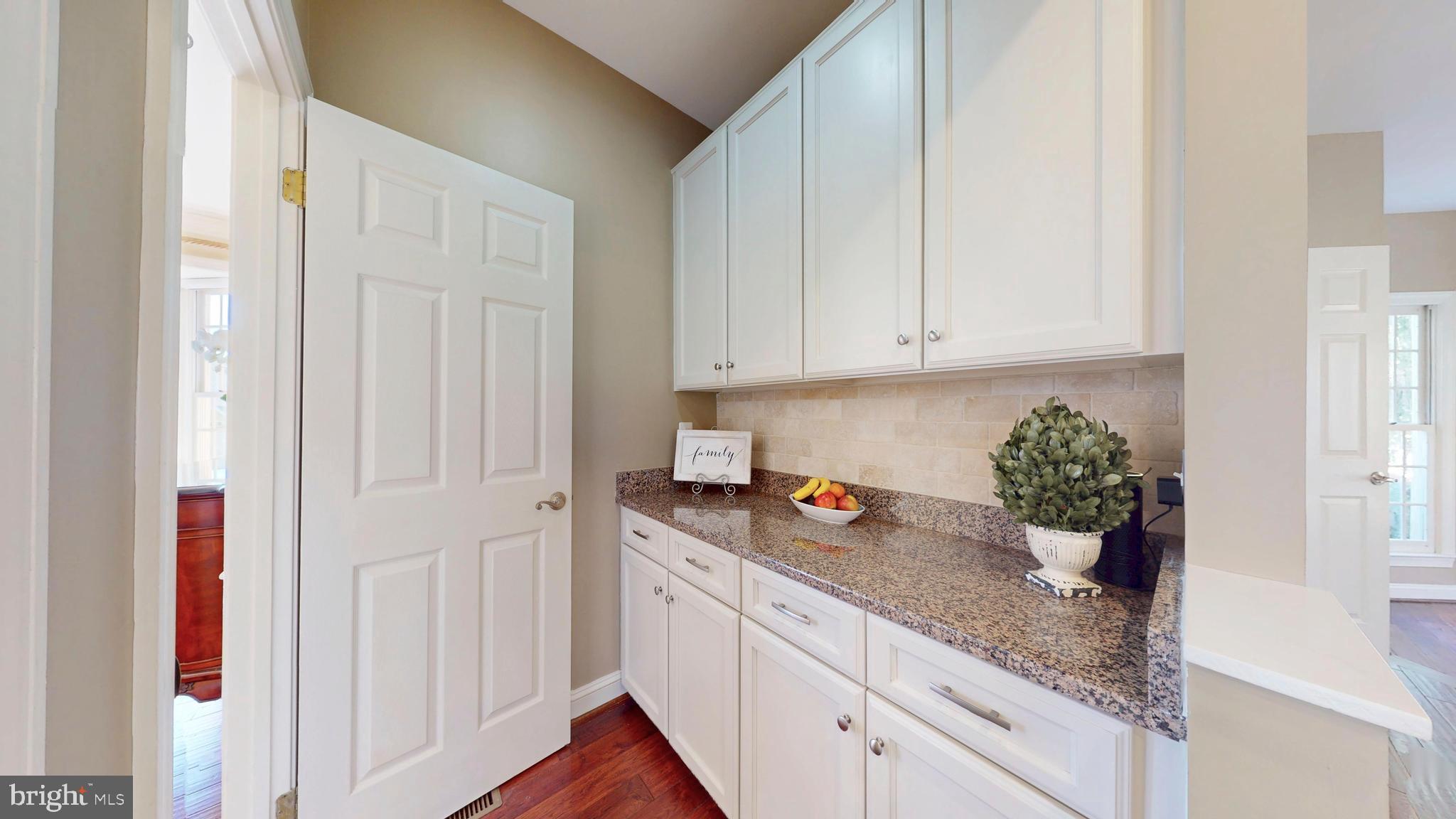 9728 Middleton Ridge Road Vienna, VA 22182 - Photo 26 of 81 a kitchen with stainless steel appliances granite countertop white cabinets and a hard wood floor