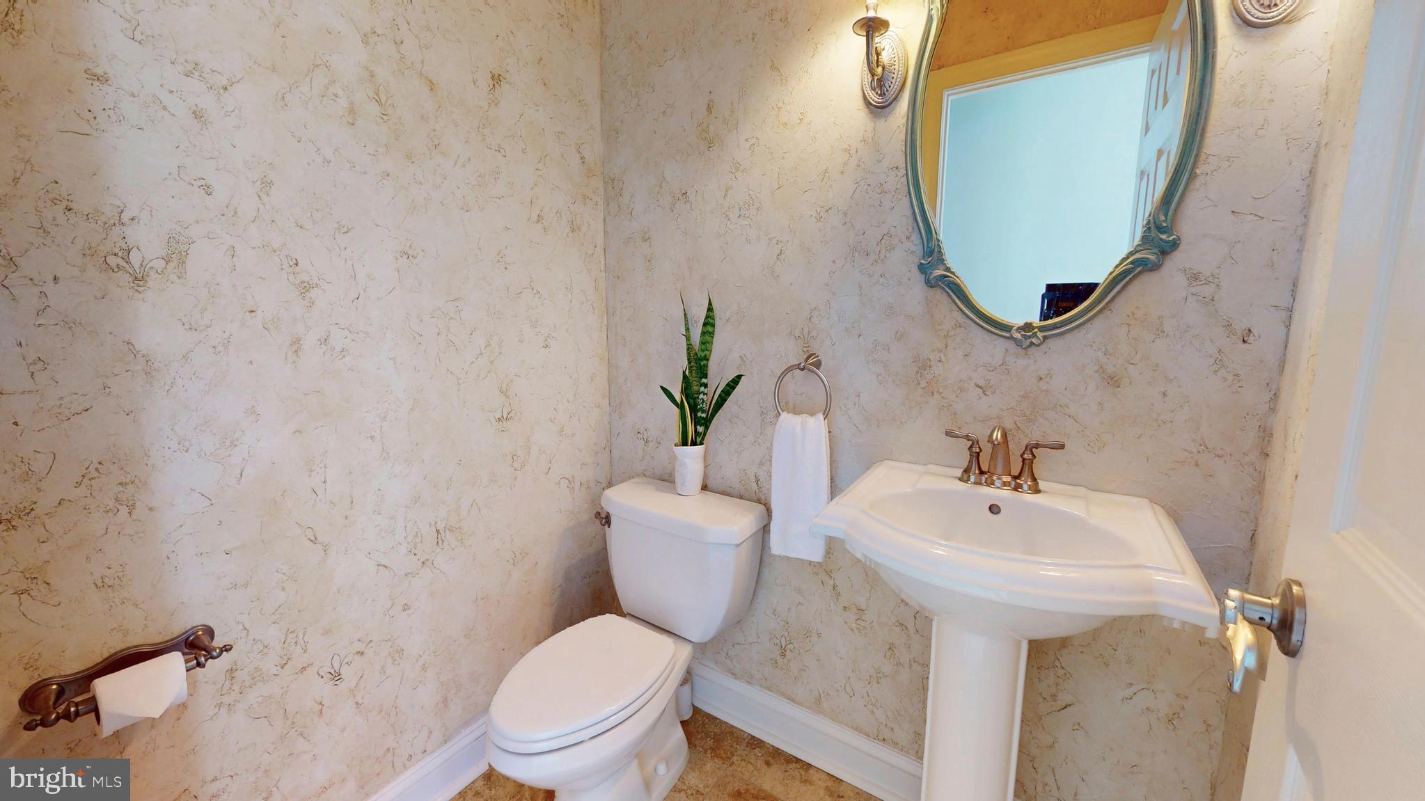 9728 Middleton Ridge Road Vienna, VA 22182 - Photo 30 of 81 a bathroom with a sink mirror and toilet
