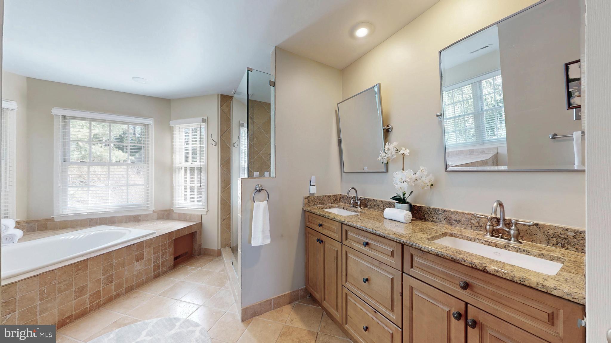9728 Middleton Ridge Road Vienna, VA 22182 - Photo 39 of 81 a bathroom with a granite countertop tub sink double vanity granite and a bathtub