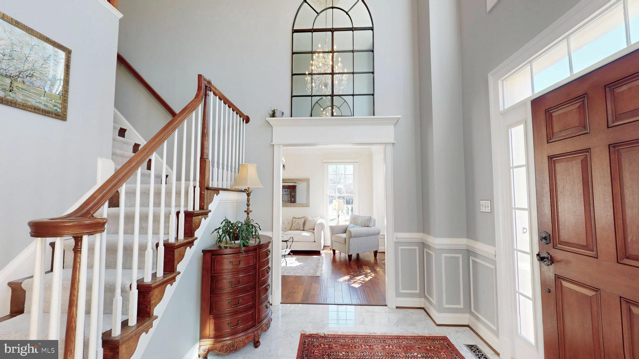 9728 Middleton Ridge Road Vienna, VA 22182 - Photo 4 of 81 a view of staircase with wooden floor and a rug