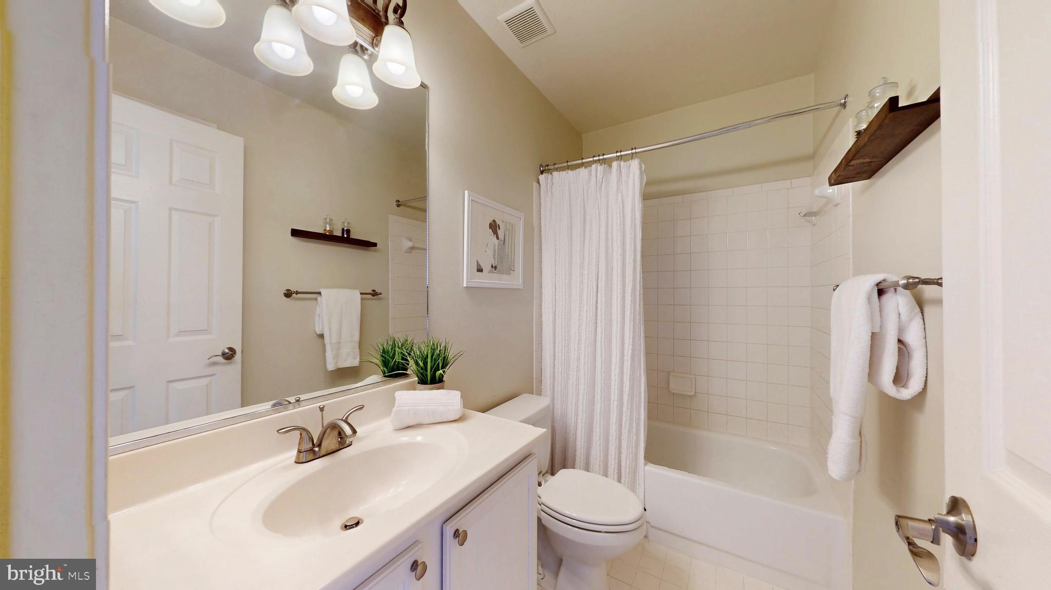 9728 Middleton Ridge Road Vienna, VA 22182 - Photo 50 of 81 a bathroom with a sink shower and a mirror
