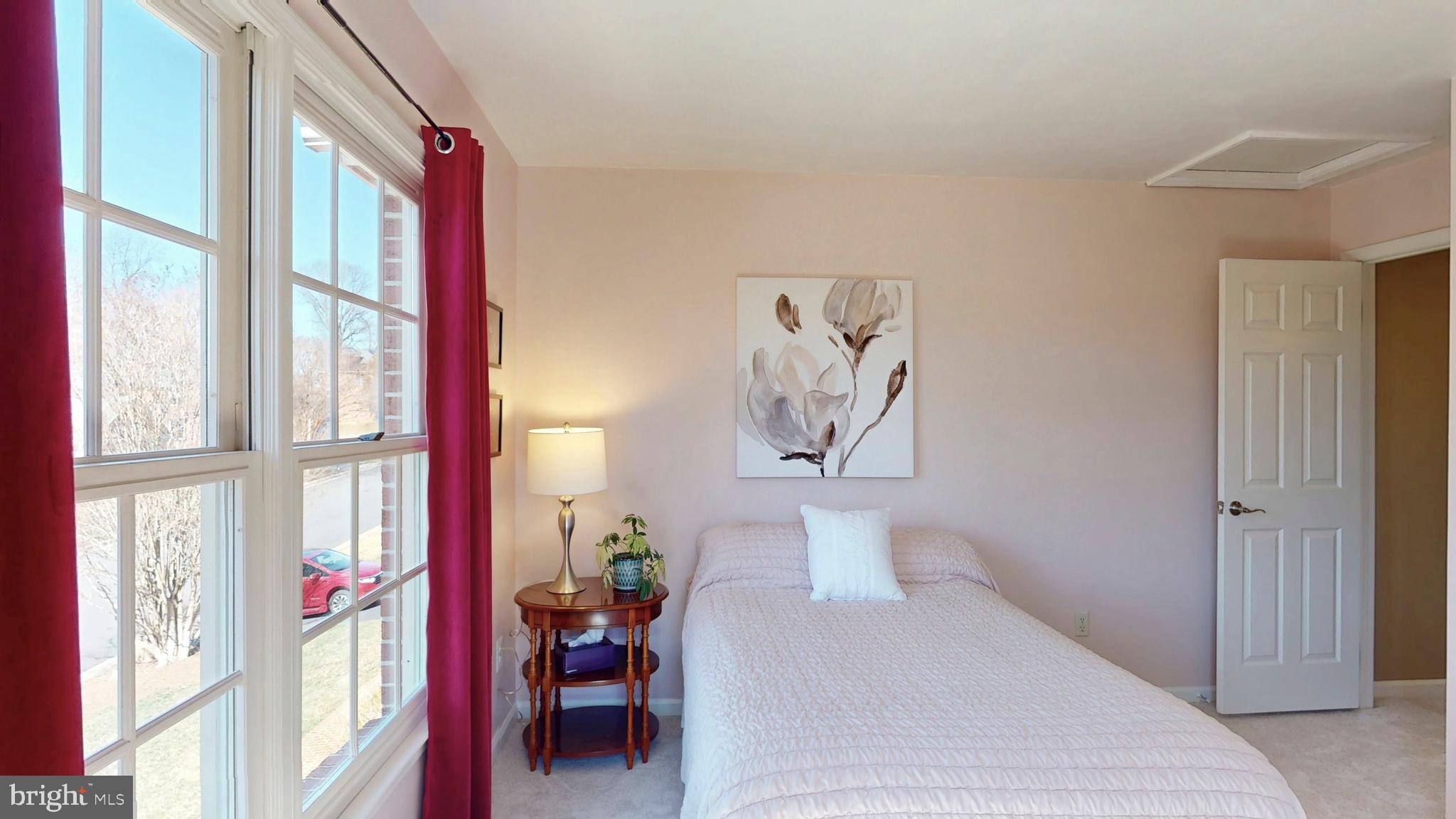 9728 Middleton Ridge Road Vienna, VA 22182 - Photo 53 of 81 a bedroom with a bed and a large window with chair