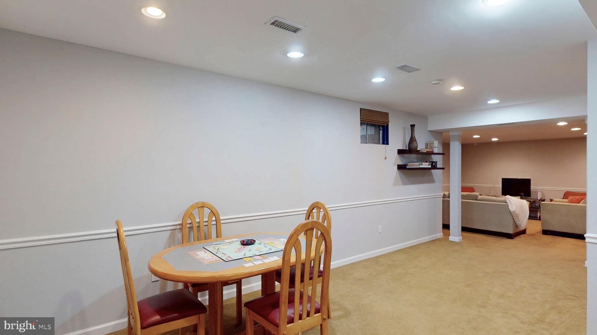 9728 Middleton Ridge Road Vienna, VA 22182 - Photo 59 of 81 a kitchen with stainless steel appliances granite countertop a sink a stove a dining table and chairs