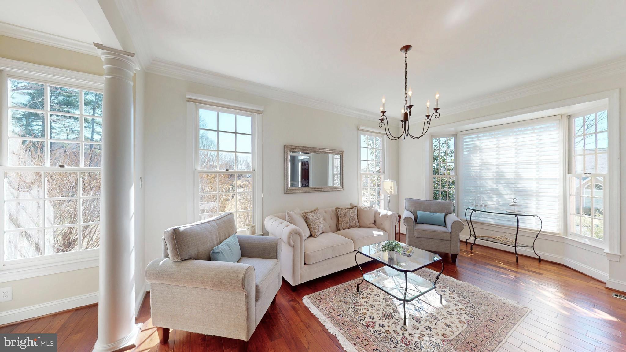 9728 Middleton Ridge Road Vienna, VA 22182 - Photo 7 of 81 a living room with furniture a chandelier and a window