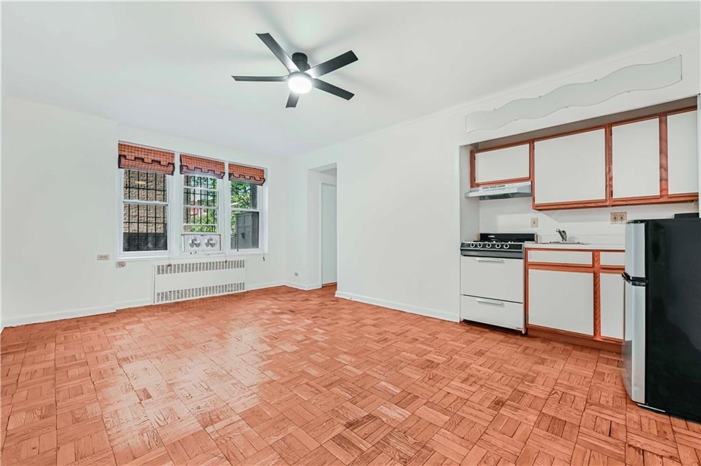 9430 Ridge Boulevard, Unit 1F Brooklyn, NY 11209 - Photo 4 of 6 a view of a kitchen with microwave and windows