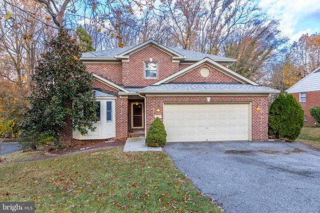 a front view of a house with yard and garage