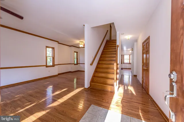 a view of entryway and hall with wooden floor