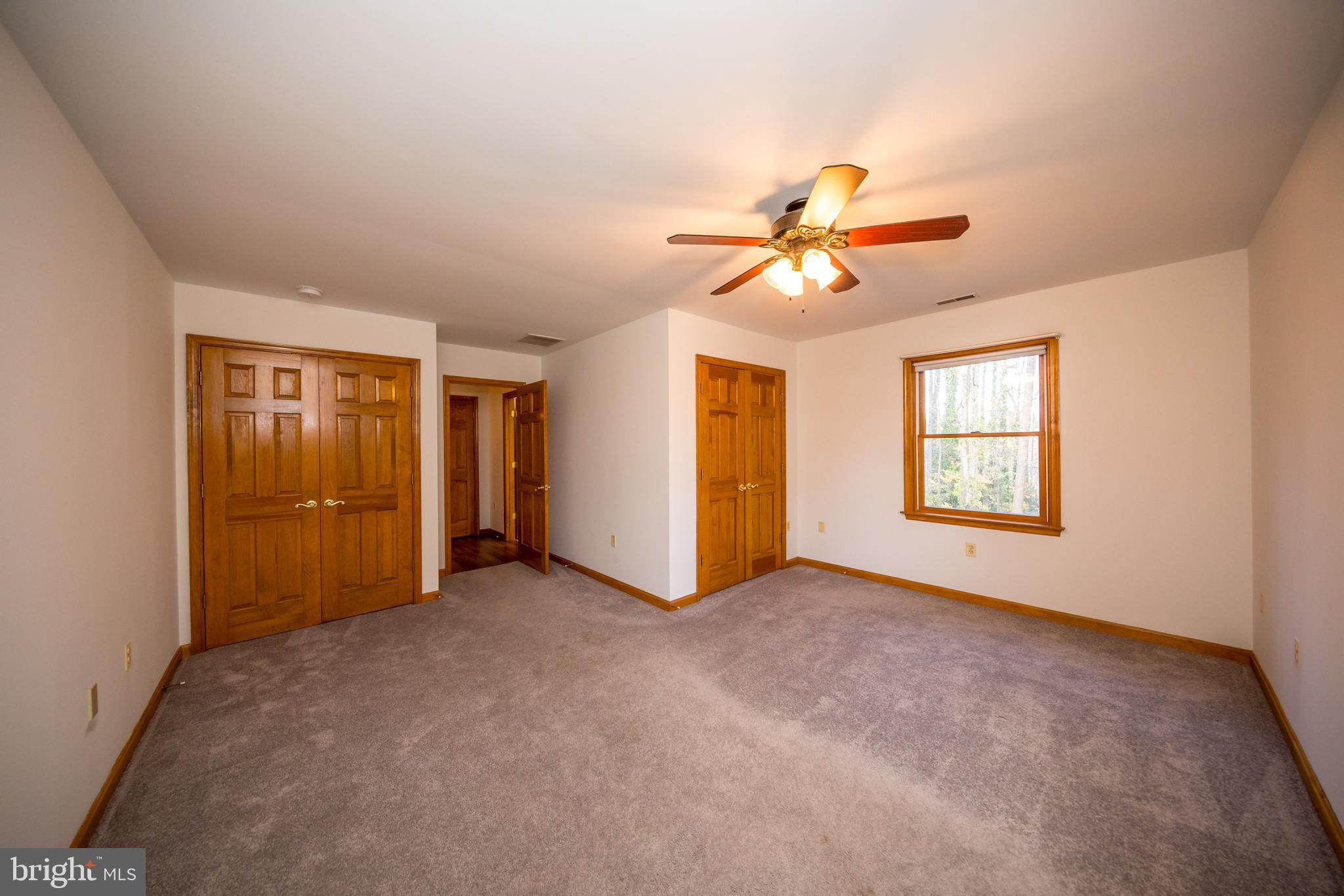 20 Glade Avenue Baltimore, MD 21236 - Photo 22 of 42 an empty room with closet and a ceiling fan