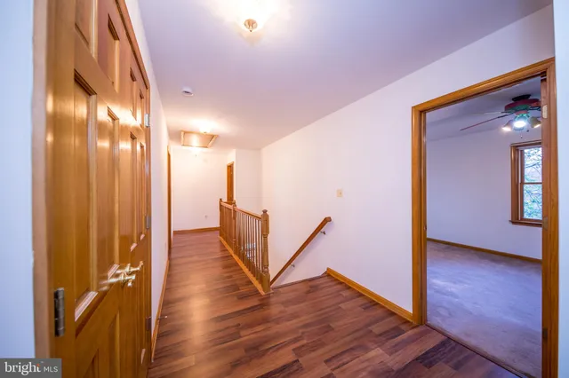 a view of a hallway with wooden floor