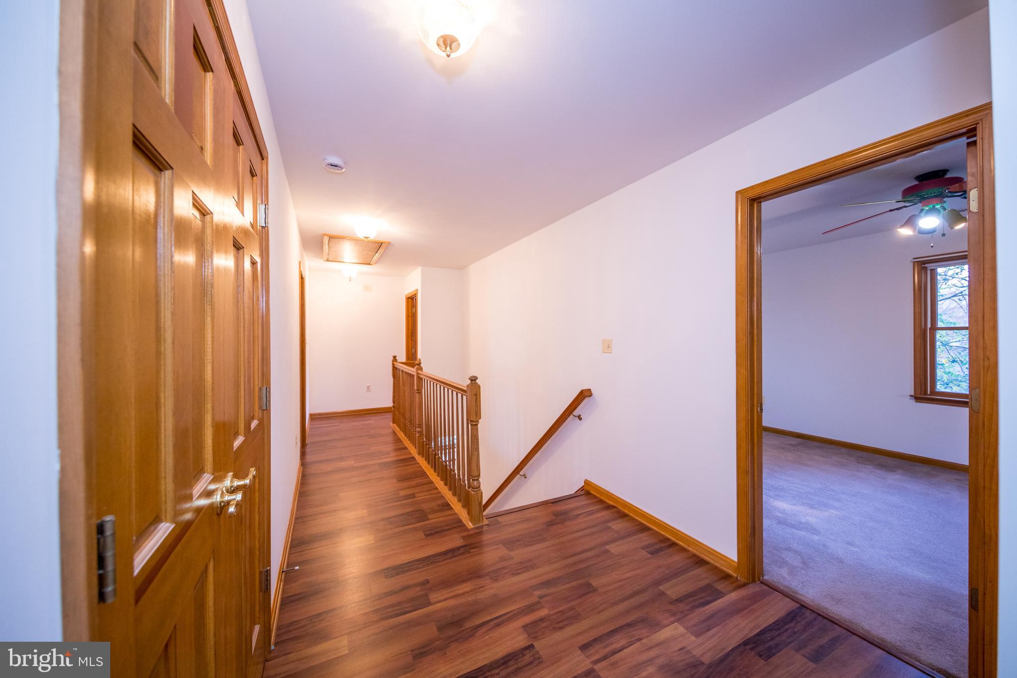 20 Glade Avenue Baltimore, MD 21236 - Photo 23 of 42 a view of a hallway with wooden floor
