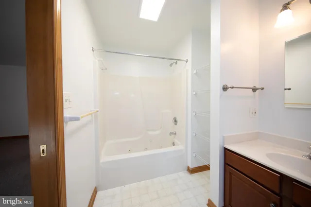 a bathroom with a bathtub a sink and a shower