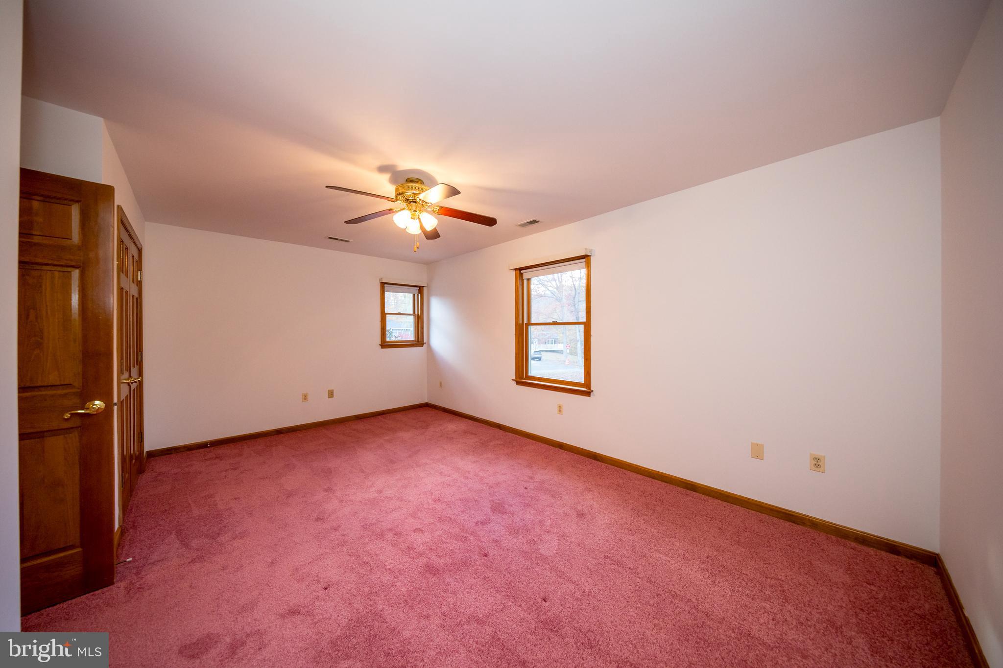 20 Glade Avenue Baltimore, MD 21236 - Photo 32 of 42 an empty room with windows and chandelier fan