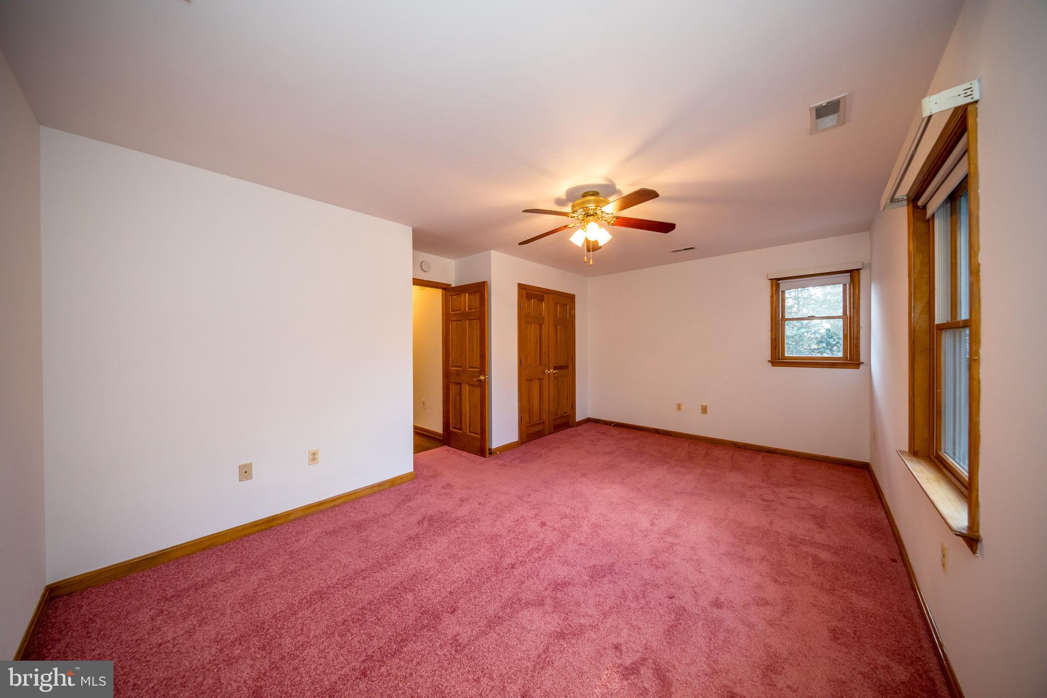 20 Glade Avenue Baltimore, MD 21236 - Photo 33 of 42 an empty room with chandelier fan and windows