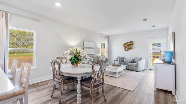 a dining room with furniture and wooden floor