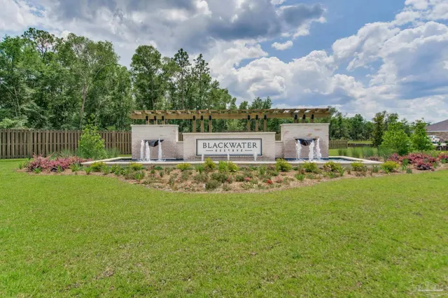 a house view with swimming pool and green space