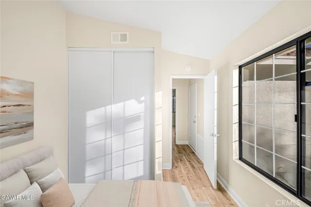 a bedroom with a bed and a potted plant