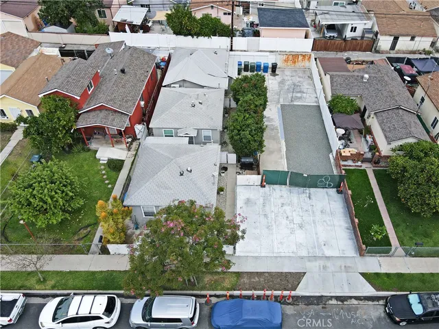 an aerial view of multiple houses with yard